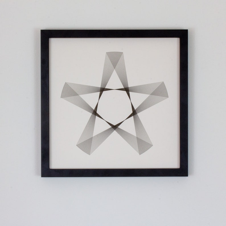 May include: A black framed print with a geometric design of a star made of thin lines.