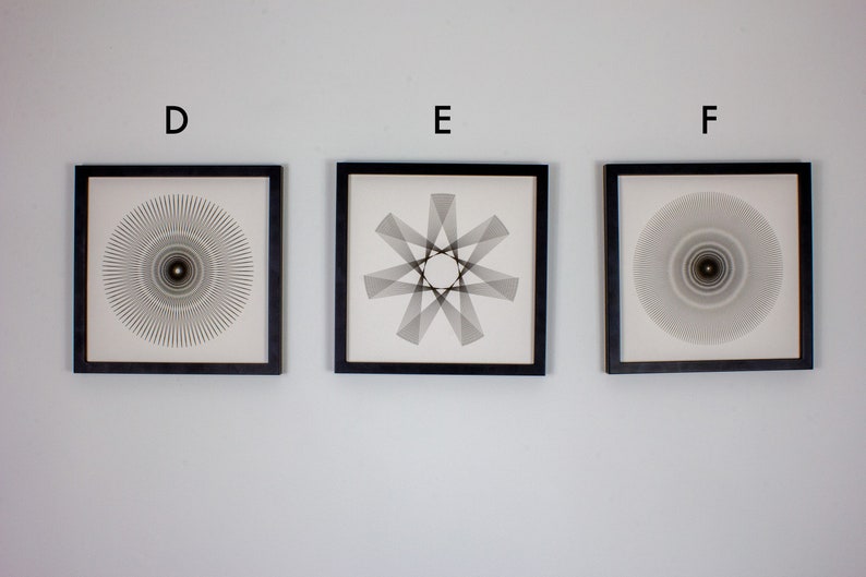 May include: Three framed black and white abstract geometric designs. The designs are all circular and feature a central point. The frames are black and have a white mat.