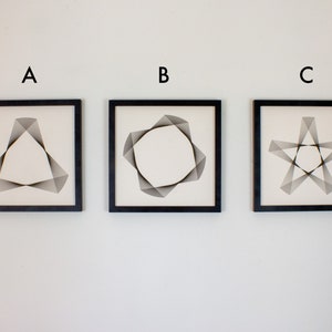 May include: Three framed black and white geometric art prints with the letters A, B, and C above each print. The print labeled A features a triangle shape, the print labeled B features a star shape, and the print labeled C features a circle shape.