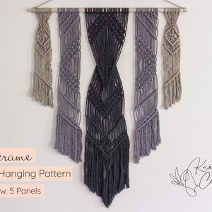 May include: Macrame wall hanging pattern with five panels in shades of grey and beige. The panels are arranged in a staggered pattern and feature a variety of knots. The hanging is made with natural fibres and has a rustic, bohemian aesthetic. Knot & Calm is the name of the shop.