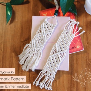 May include: Two white macrame bookmark patterns with fringe on a pink and white book. The bookmark patterns are beginner and intermediate level. The text "Knot Calm" is visible in the bottom right corner of the image.