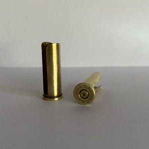 May include: Two brass bullet casings, one with the inscription "38 SPL CBC" on the side.