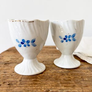 Vintage 1950s porcelain white egg cups with blue flowers - set of 2