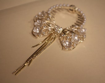 Gold bow with flowers and pearls