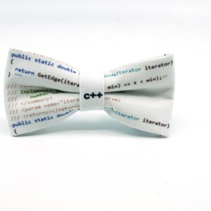 May include: White bow tie with a C++ logo and code printed on it. The code includes the text "public static double return GetEdge(iterator)" and "modelterator iterator) min) => t < min);"