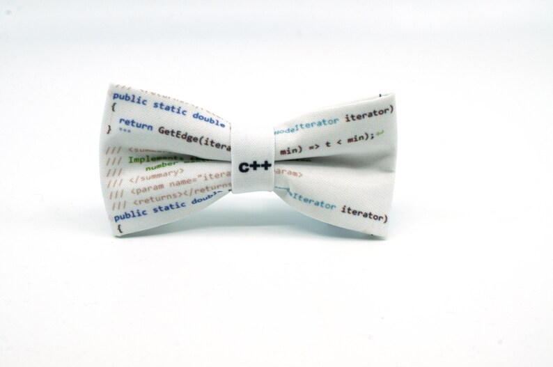 May include: White bow tie with a C++ logo and code printed on it. The code includes the text "public static double return GetEdge(iterator)" and "modelterator iterator) min) => t < min);"