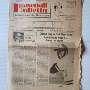 May include: A vintage April 1975 issue of The Baseball Bulletin newspaper. The front page features a black and white photograph of a baseball player named Colbert, headlines about home run records, and an article about Ernie Harwell.