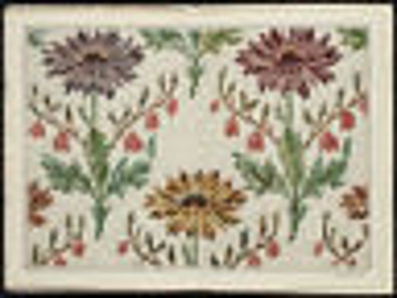 May include: A white ceramic tile with a floral design. The tile features four stylized flowers in shades of purple, pink, yellow, and green. The flowers are surrounded by green leaves and stems.