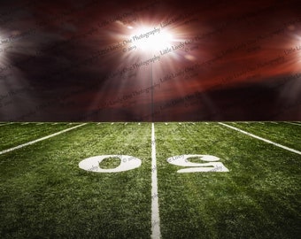 May include: A green football field with white yard lines and a white '09' painted on the field. The field is lit by bright spotlights against a dark red sky.