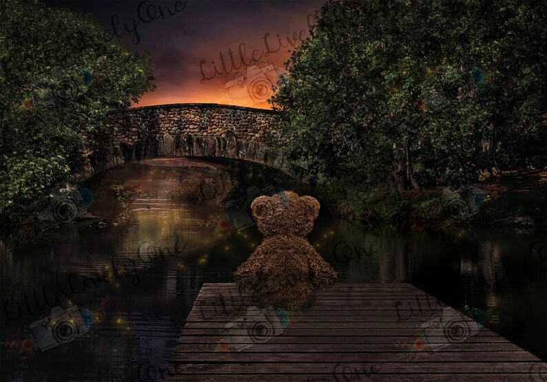 May include: A brown teddy bear sits on a wooden dock overlooking a dark, still pond. The pond is surrounded by trees and a stone bridge. The sky is a soft orange and purple.