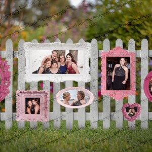 May include: A white picket fence displays various framed photos in different shapes and sizes. The frames are in shades of pink and white, with photos of groups of people. The background features green grass and a blurred garden.