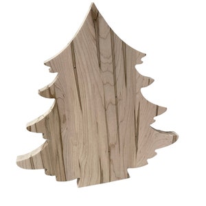 May include: A wooden Christmas tree ornament with a natural wood grain pattern. The tree is cut out of a single piece of wood and has a rustic, handmade look.