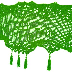 May include: Bright green crocheted shawl with the words "Good Days on Time" visible. The shawl has a scalloped edge and decorative tassels hanging from the bottom. The open weave design is visible throughout the shawl.