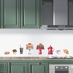 May include: A kitchen backsplash featuring watercolour-style decals of pastries, coffee, and a croissant. The decals are on a white background and are arranged in a row. The kitchen cabinets are green.