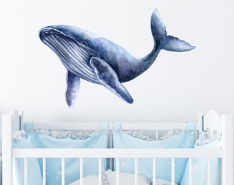May include: A watercolor illustration of a blue whale, perfect for a nursery or child's room. The whale is depicted swimming upwards with its mouth open.