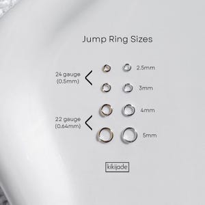 May include: A white background displays jump ring sizes. The text "Jump Ring Sizes" is at the top. Jump rings are shown in various sizes, including 2.5mm, 3mm, 4mm, and 5mm. The text "24 gauge (0.5mm)" and "22 gauge (0.64mm)" are also present.