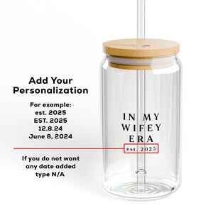 May include: A clear glass jar with a wooden lid and a straw. The jar has the text "IN MY WIFEY ERA est. 2025" printed on it.