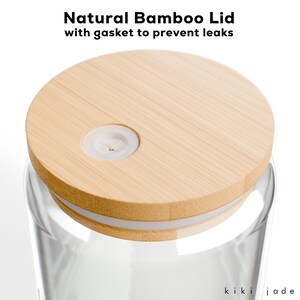 May include: A clear glass jar with a natural bamboo lid. The lid has a white gasket to prevent leaks. The lid has a small hole in the center.