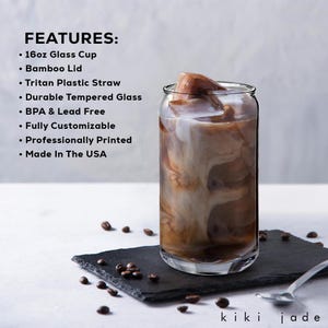 May include: A 16-ounce glass cup with a bamboo lid and a Tritan plastic straw. The cup is filled with iced coffee and ice cubes. The cup is made of durable tempered glass and is BPA and lead free. It is fully customizable and professionally printed. Made in the USA.