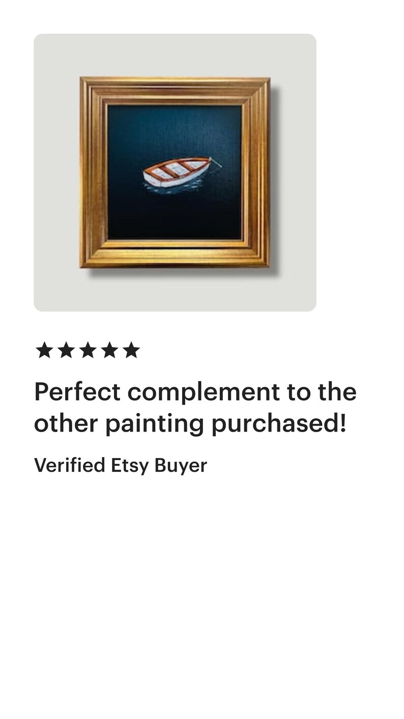 May include: A framed painting depicting a small boat on dark blue water. The boat is white and brown, and the frame is gold. The painting is square and is displayed on a white background.