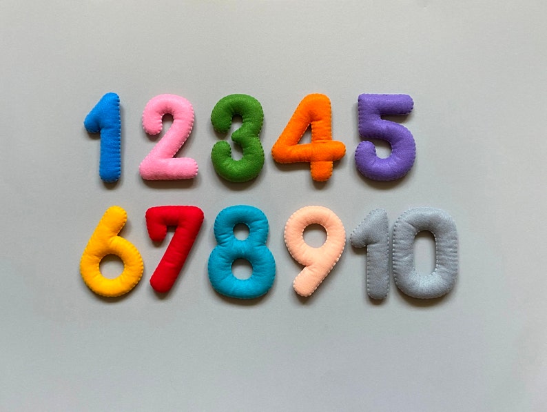 May include: Felt numbers 1 to 10 in various colours. The numbers are arranged in two rows, with the first row containing numbers 1 to 6 and the second row containing numbers 7 to 10.