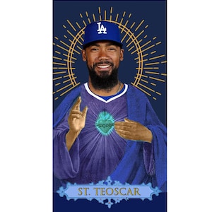 May include: A digital illustration of a baseball player wearing a blue and white baseball uniform with a blue baseball cap featuring the letters "LA". The player has a beard and is depicted with a heart in his chest. The background is a dark blue with a gold halo behind the player. The text "ST. TEOSCAR" is at the bottom of the image.