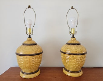 A large pair of ceramic faux wicker lamps