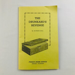 May include: A yellow pamphlet with a black and white illustration of a wooden box with the title "The Drunkard's Revenge" by Raymond Hull. The pamphlet is for the Pioneer Drama Service in Denver, Colorado.