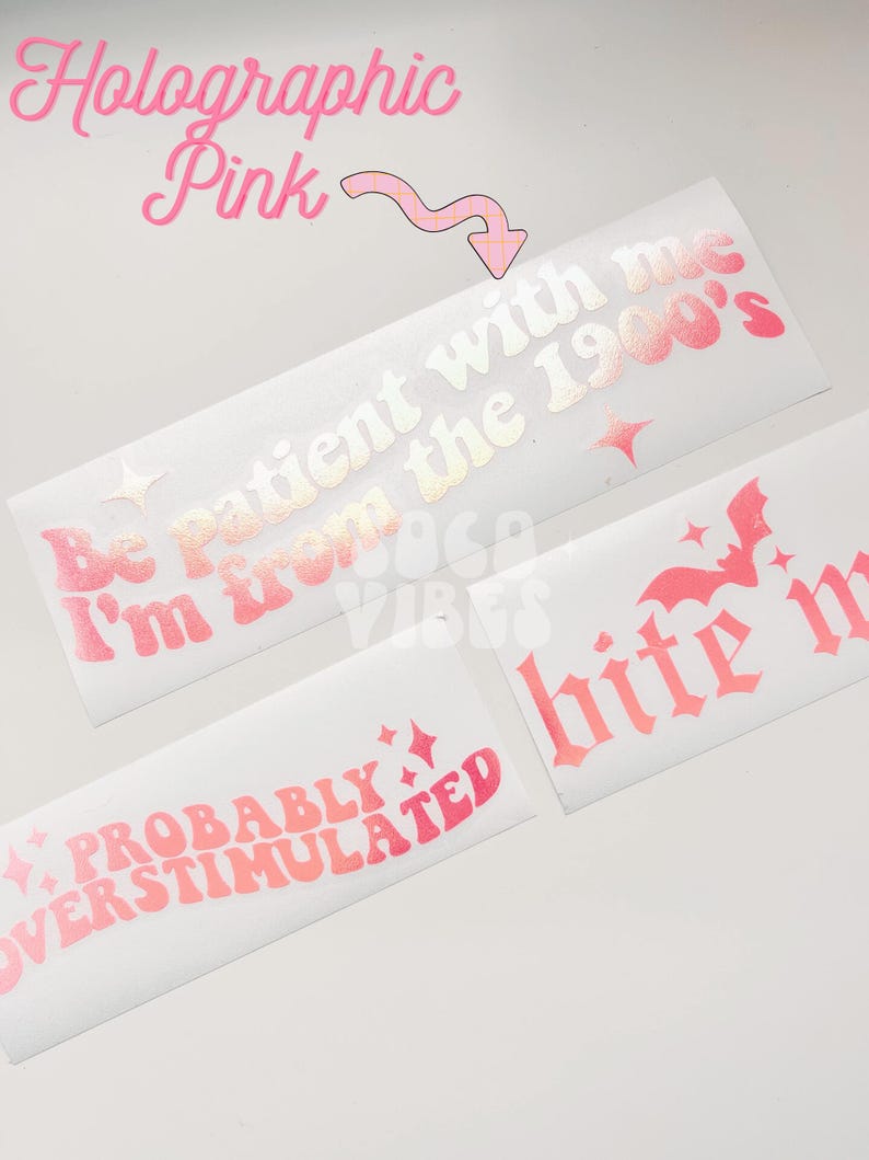 May include: Three holographic pink vinyl stickers with different phrases. The first sticker says "Be patient with me I'm from the 1900's". The second sticker says "Probably Overstimulated". The third sticker says "bite me".