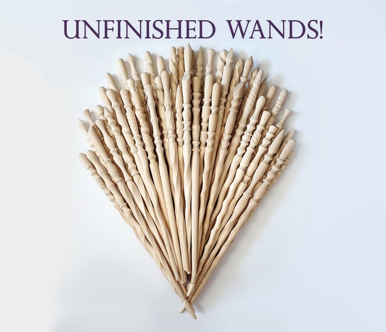 May include: A collection of unfinished wooden wands, arranged in a fan shape. The wands are all different shapes and sizes, and they are ready to be painted or decorated.