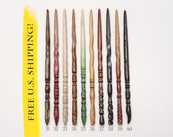 May include: A collection of ten slender, hand-carved wooden wands arranged vertically in a row. Each wand features a unique texture, ranging from smooth, twisted, and spiraled designs to carved patterns, in various shades of brown, tan, and green.