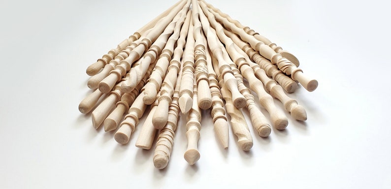 May include: A collection of 20 unfinished wooden wands, each with a unique design and shape. The wands are made of natural wood and have a smooth, polished finish.
