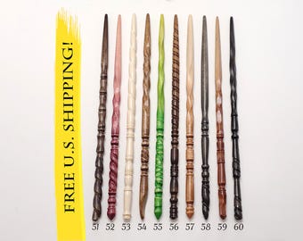 May include: Ten slender wooden wands arranged vertically and numbered 51 through 60. The wands feature various finishes including dark brown, light pink, cream, natural wood, green, and black, with carved textures like spirals and rings.