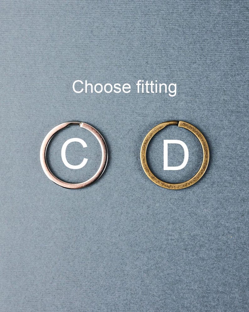 May include: Two metal key rings, one silver and one gold, with the letters "C" and "D" printed on them. Choose fitting.