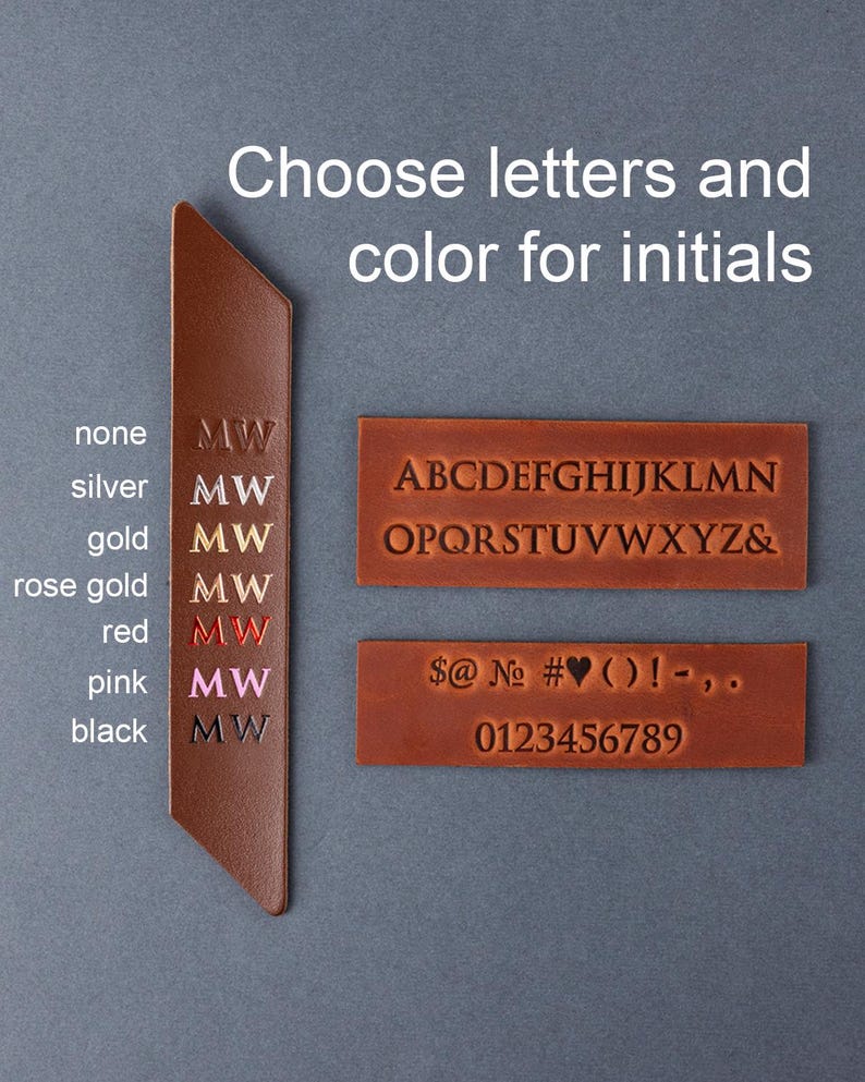 May include: A brown leather bookmark with the text "Choose letters and color for initials." The bookmark has the letters "MW" in various colours, including silver, gold, rose gold, red, pink, and black. Alphabet and number samples are also shown.