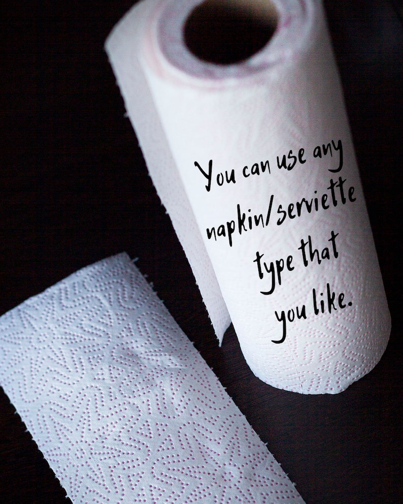 May include: A white paper towel roll with the text "You can use any napkin/serviette type that you like." written on it.