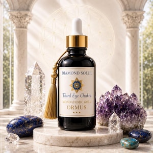 May include: A dark glass bottle with a gold cap and a white label reading "Diamond Soleil Third Eye Chakra Monoatomic Gold ORMUS." The bottle has a gold tassel and is surrounded by crystals and gemstones.