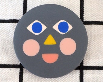 Happy face brooch