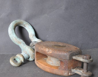 Vintage wooden pulley and brass shackle