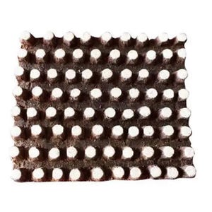 May include: A brown wooden block with a raised pattern of white circles. The block is used for printing designs onto fabric.