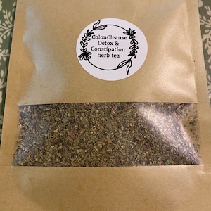 May include: A brown paper bag with a white circle label that says "ColonCleanse Detox & Constipation herb tea". The bag contains loose leaf tea.