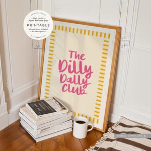 printable wall art. a trendy fun quote with the words: 'the dilly dally club' written in a funky cool font in a pink colour on a neutral beige background with a pink and  white boarder. this would suit any home interior space. multiple sizes are included. this is a digital download.