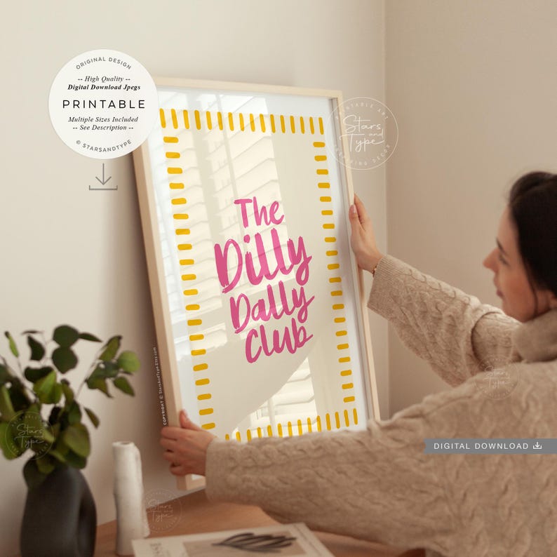 printable wall art. a trendy fun quote with the words: 'the dilly dally club' written in a funky cool font in a pink colour on a neutral beige background with a pink and  white boarder. this would suit any home interior space. multiple sizes are included. this is a digital download.