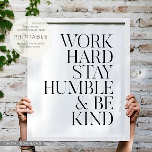 以下が含まれることがあります： 白い額縁の印刷可能なポスターで、黒い文字で「WORK HARD STAY HUMBLE & BE KIND」と書かれています。