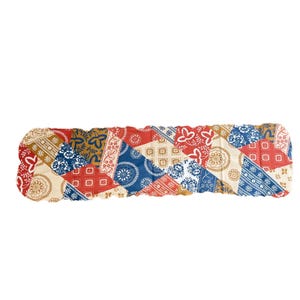 May include: A long, rectangular fabric runner featuring a patchwork design of various patterns in shades of red, blue, cream, and mustard yellow. The print includes floral motifs, geometric squares, and circular mandala-like designs throughout.
