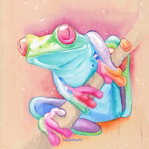May include: A watercolor painting of a vibrant green and blue frog with pink eyes and limbs. The frog is perched on a branch with its legs curled up. The background is a light pink with white speckles.