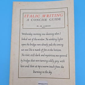 May include: A vintage book cover titled "ITALIC WRITING A CONCISE GUIDE" by W. M. Aaron. The cover is off-white with a rectangular border and features text from a poem. The Transatlantic Arts logo is at the bottom.