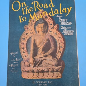 May include: Sheet music cover titled "On the Road to Mandalay" with a seated Buddha image. The text is in yellow and white against a dark blue background. The cover also includes the names Oley Speaks and Rudyard Kipling.