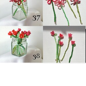 May include: Two sets of handcrafted beaded flowers labeled 37 and 38. Set 37 features red daisy-like flowers with green beaded stems. Set 38 features red tulip-like flowers with green beaded stems. Each set is displayed in a clear glass jar.