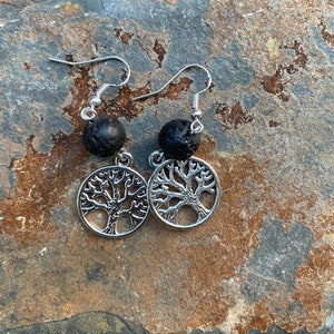 May include: A pair of silver tree of life earrings with black lava rock beads.